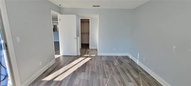a view of a room with wooden floor