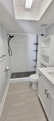 a bathroom with a toilet and a shower