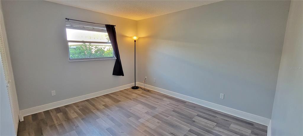 3342 Teeside Drive New Port Richey, FL 34655 - Photo 30 of 45 a view of an empty room with wooden floor and a window