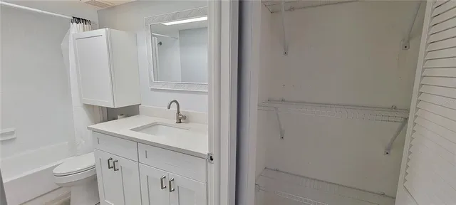 a bathroom with a sink toilet vanity and a mirror