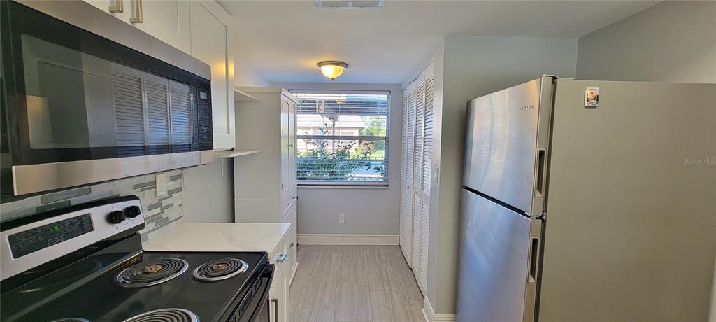 3342 Teeside Drive New Port Richey, FL 34655 - Photo 6 of 45 a kitchen with a refrigerator and a stove top oven
