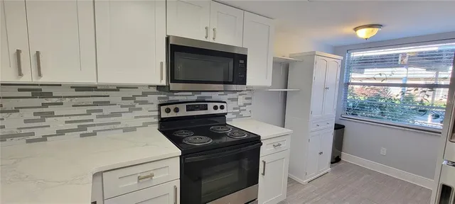 a kitchen with a stove and a microwave