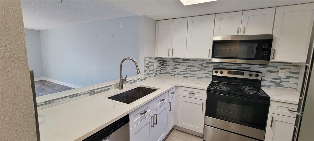 3342 Teeside Drive New Port Richey, FL 34655 - Photo 9 of 45 a kitchen with a stove and a microwave