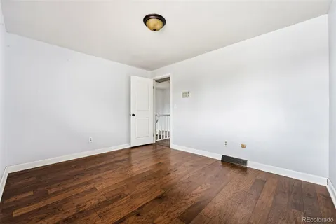 a living room with furniture and a ceiling fan