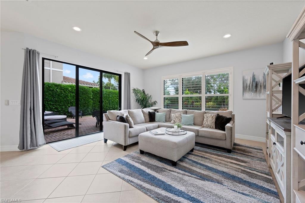 3082 Hudson Terrace Naples, FL 34119 - Photo 19 of 48 a spacious bedroom with a large bed and a flat tv screen