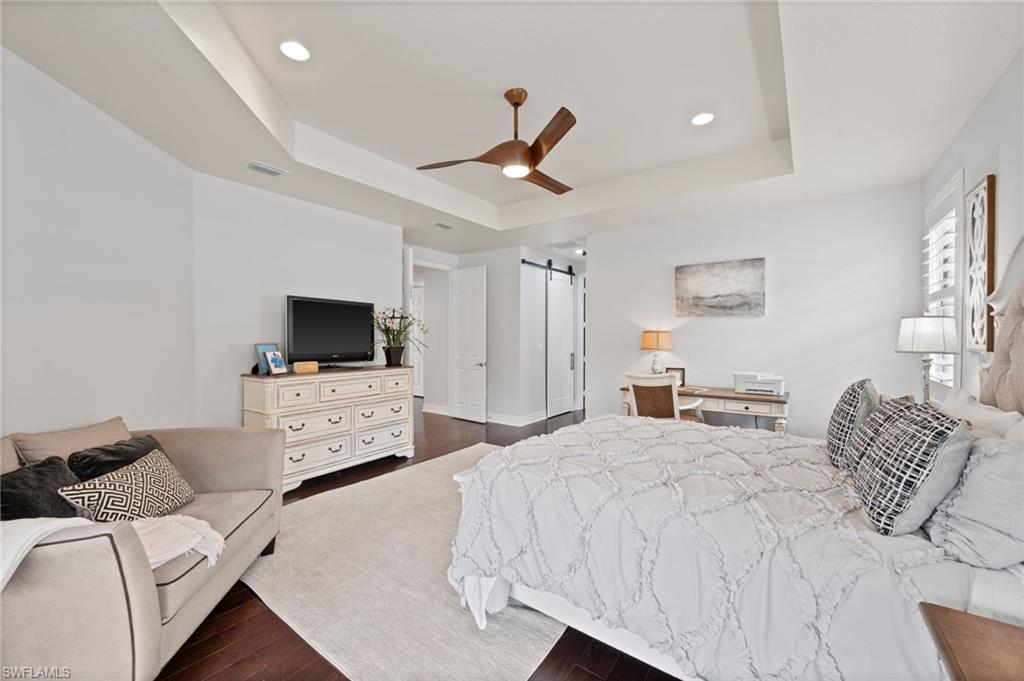 3082 Hudson Terrace Naples, FL 34119 - Photo 27 of 48 a bedroom with a bed and a flat screen tv