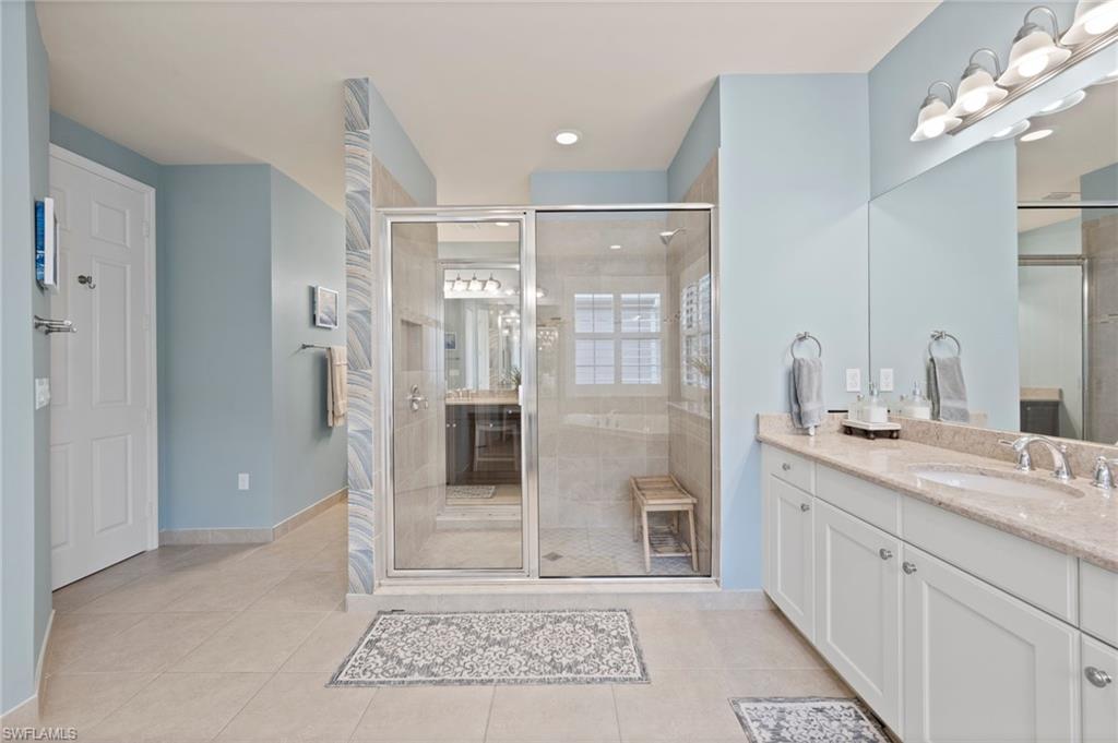 3082 Hudson Terrace Naples, FL 34119 - Photo 32 of 48 a spacious bathroom with a granite countertop sink a mirror and shower