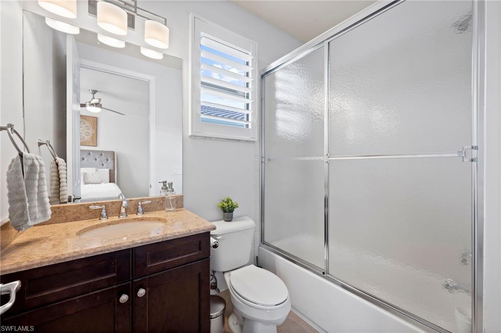 3082 Hudson Terrace Naples, FL 34119 - Photo 35 of 48 a bathroom with a granite countertop sink toilet and shower