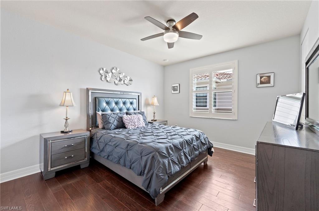 3082 Hudson Terrace Naples, FL 34119 - Photo 36 of 48 a bedroom with a bed chandelier and a window