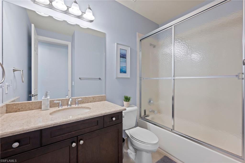 3082 Hudson Terrace Naples, FL 34119 - Photo 37 of 48 a bathroom with a sink a toilet a mirror and shower