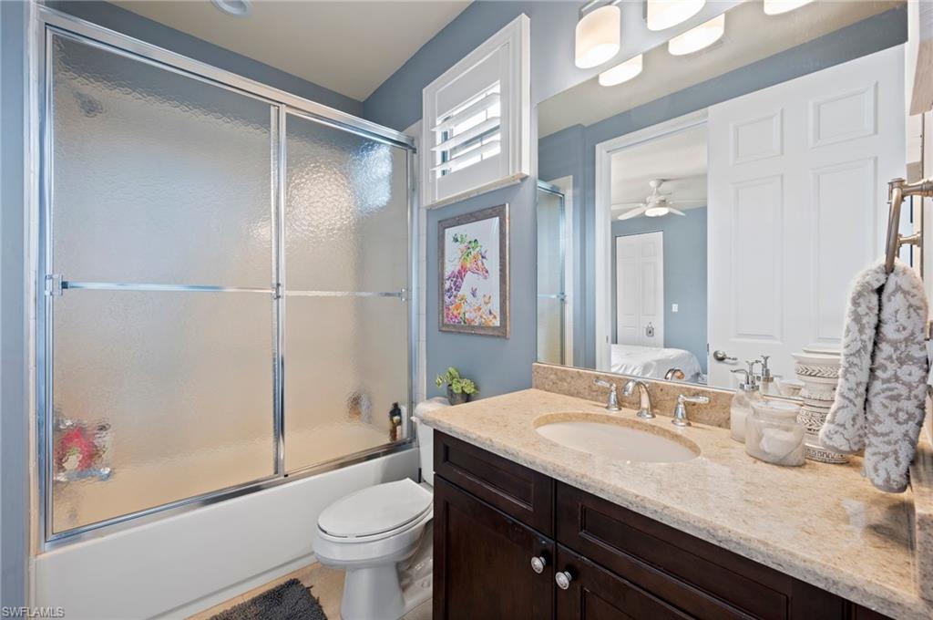 3082 Hudson Terrace Naples, FL 34119 - Photo 40 of 48 a bathroom with a granite countertop sink toilet and shower