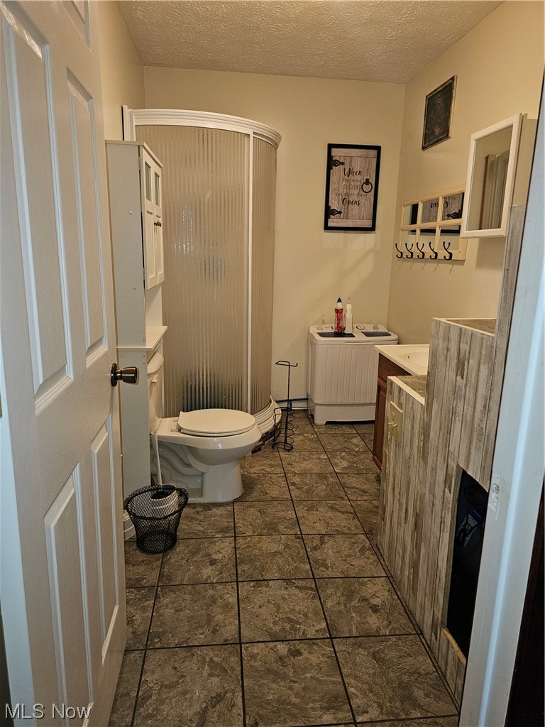 436 Davidson Ridge Road Palestine, WV 26160 - Photo 14 of 27 Bathroom featuring vanity, dark tile flooring, and a textured ceiling