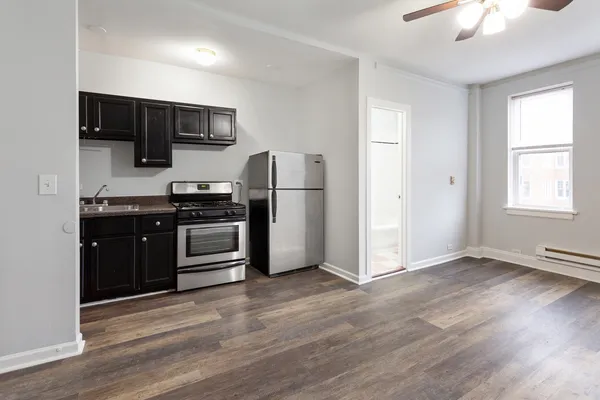 a kitchen with stainless steel appliances a stove microwave and refrigerator