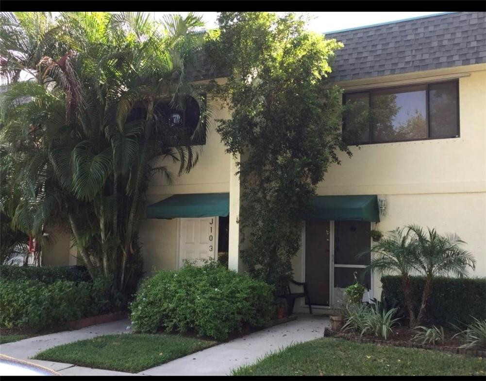 81 Deer Creek Road, Unit J103 Deerfield Beach, FL 33442 - Photo 1 of 8 a front view of a house with garden