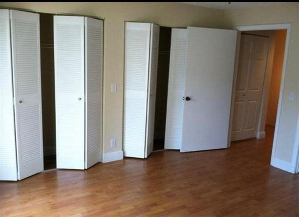 81 Deer Creek Road, Unit J103 Deerfield Beach, FL 33442 - Photo 6 of 8 a view of an empty room with closet and wooden floor