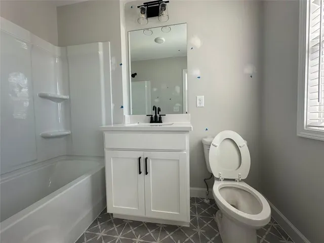 a bathroom with a sink a toilet and bathtub