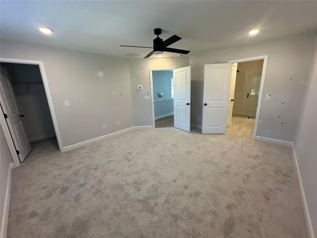 an empty room with windows and bathroom view
