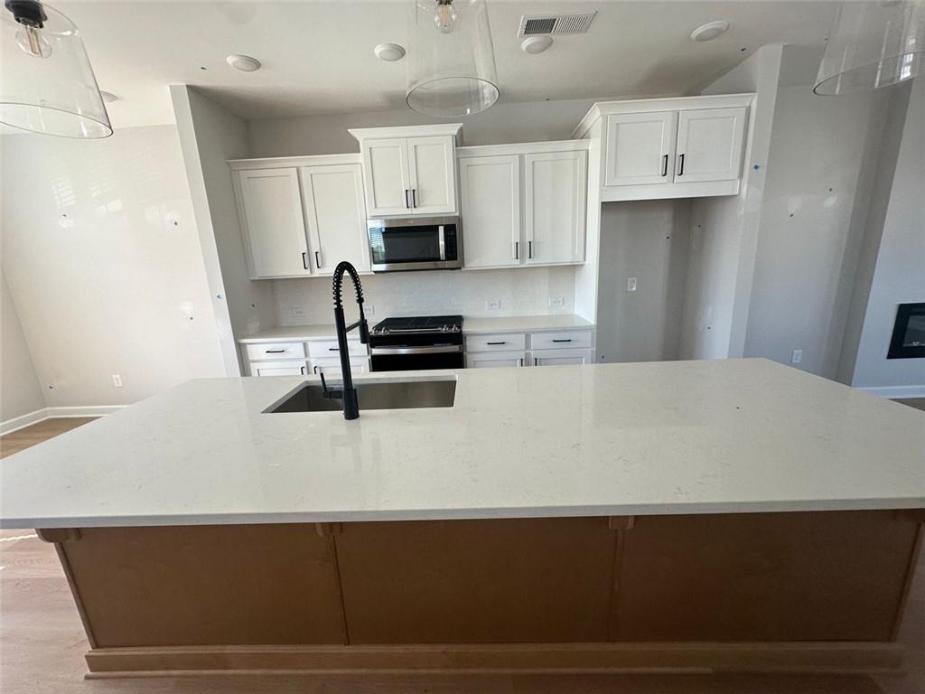 1925 Audra Alley Kennesaw, GA 30144 - Photo 4 of 24 a kitchen with cabinets and white appliances