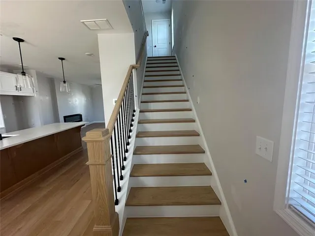 a view of entryway and hall with wooden floor