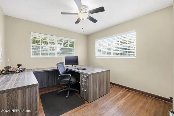 a view of a workspace with furniture and a window