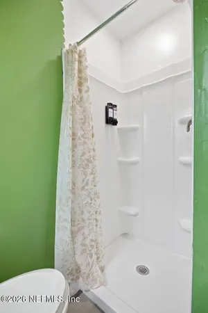 a bathroom with a shower and a toilet