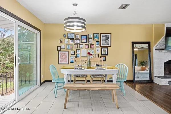 a view of a dining room with furniture and chandelier