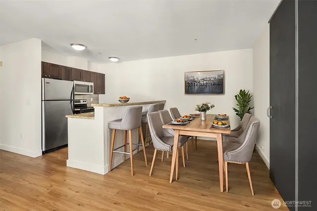 a view of a dining room with furniture and wooden floor