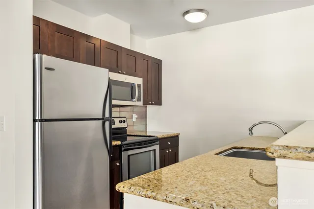 a kitchen with a refrigerator sink and stove