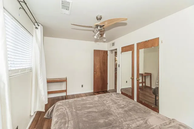 a bedroom with a bed and a dresser