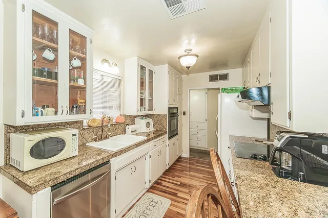 a kitchen with a sink stove and refrigerator