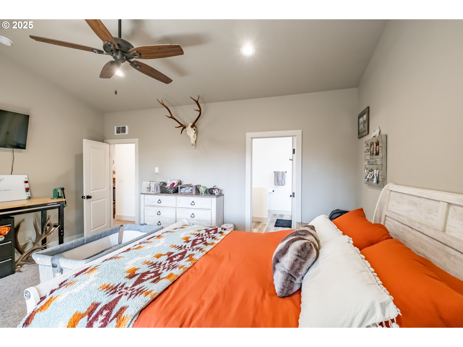 547 West Fourth Street Coquille, OR 97423 - Photo 26 of 48 a bedroom with a bed and a chandelier