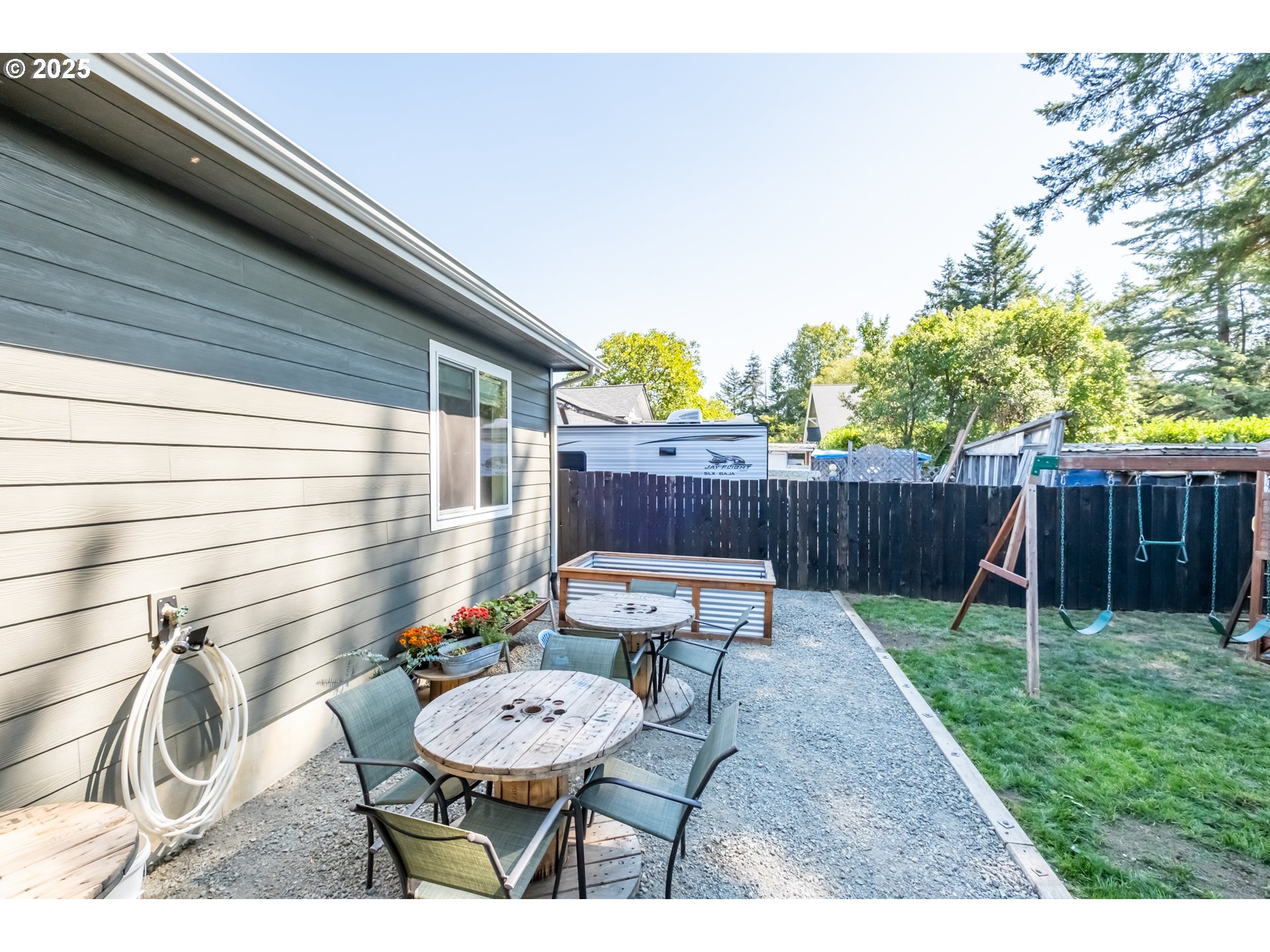 547 West Fourth Street Coquille, OR 97423 - Photo 43 of 48 a backyard of a house with table and chairs