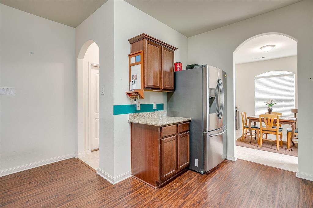 136 Kennedy Drive Venus, TX 76084 - Photo 4 of 27 a kitchen with stainless steel appliances granite countertop a refrigerator and a stove top oven