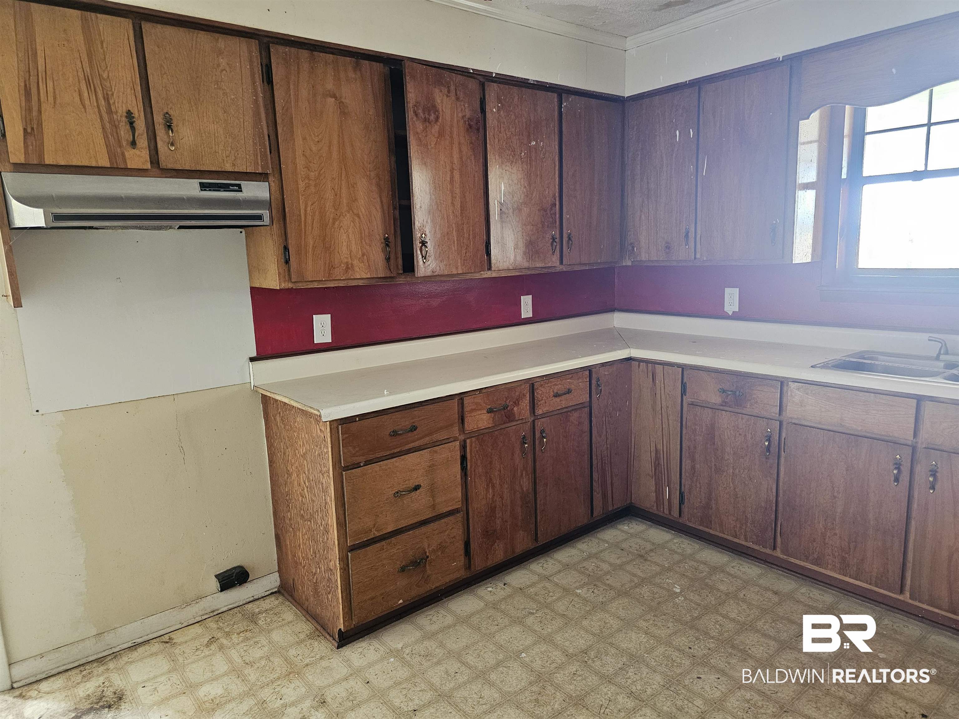 59575 Lottie Road Atmore, AL 36502 - Photo 10 of 23 Kitchen with a sink, light floors, crown molding, light countertops, and range hood