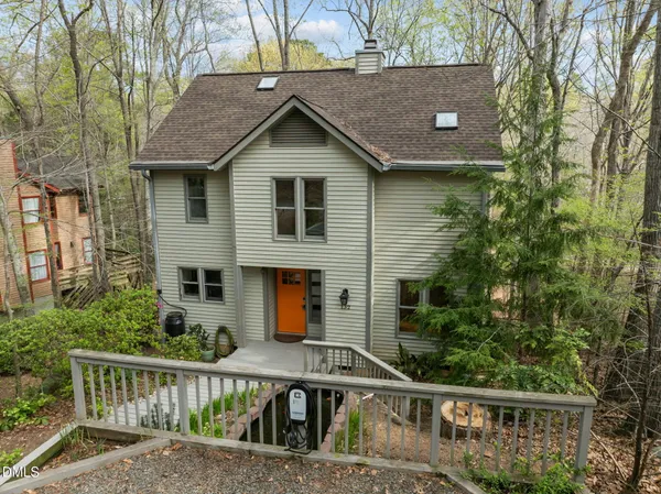 a front view of house with deck and yard