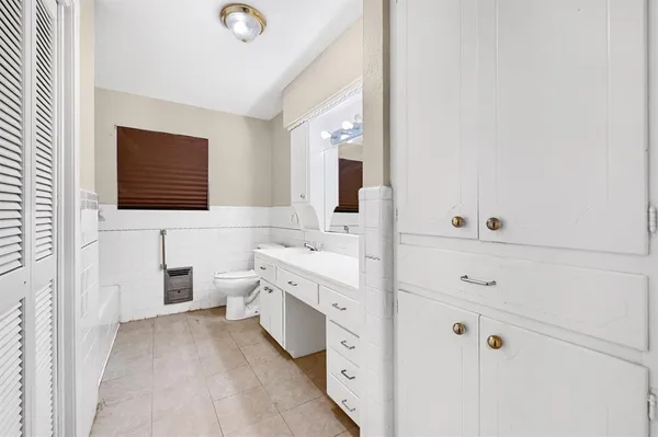 a bathroom with a double vanity sink a mirror and a bathtub