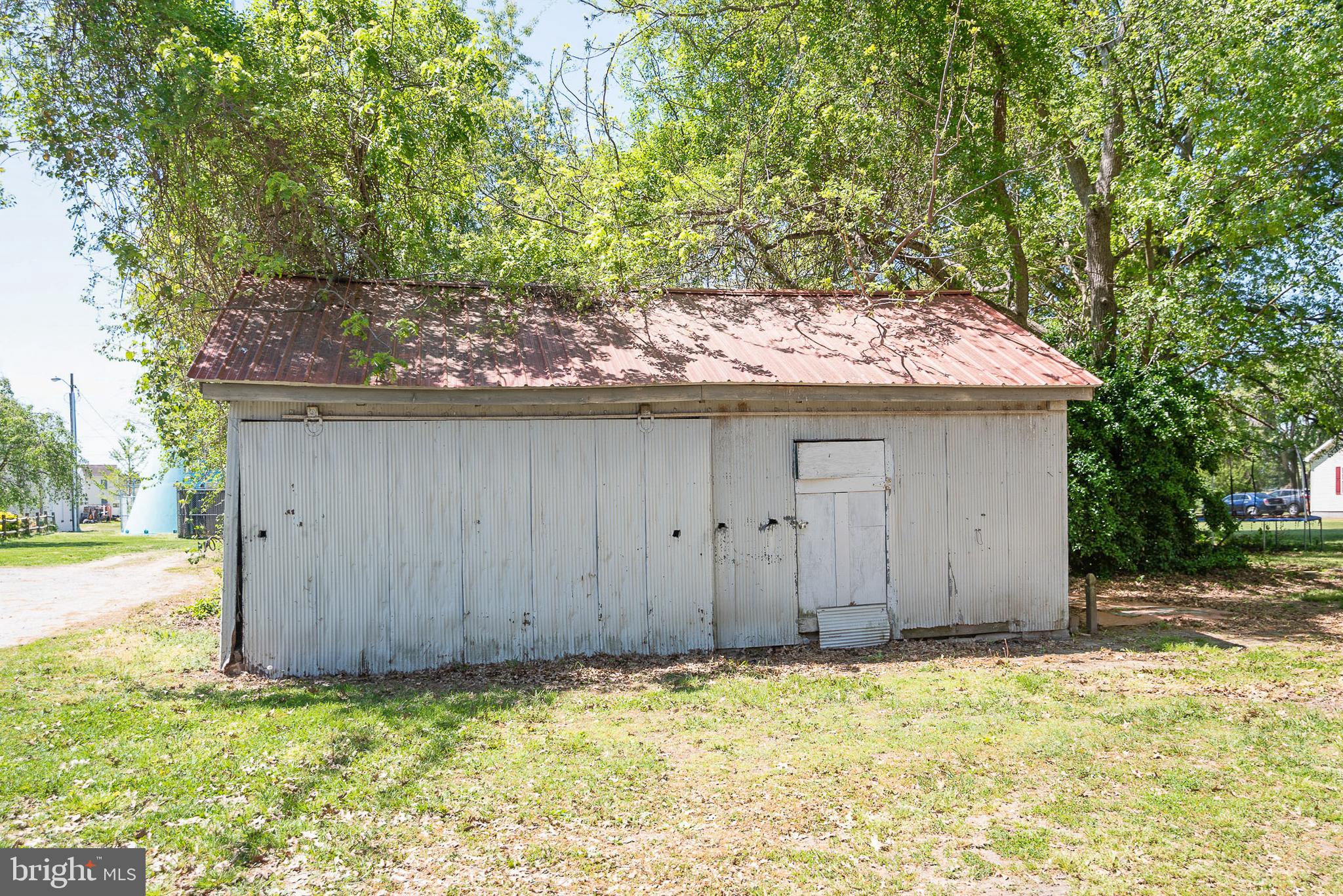 156 Main Street Preston, MD 21655 - Photo 13 of 18 a wooden door covered with trees in the background