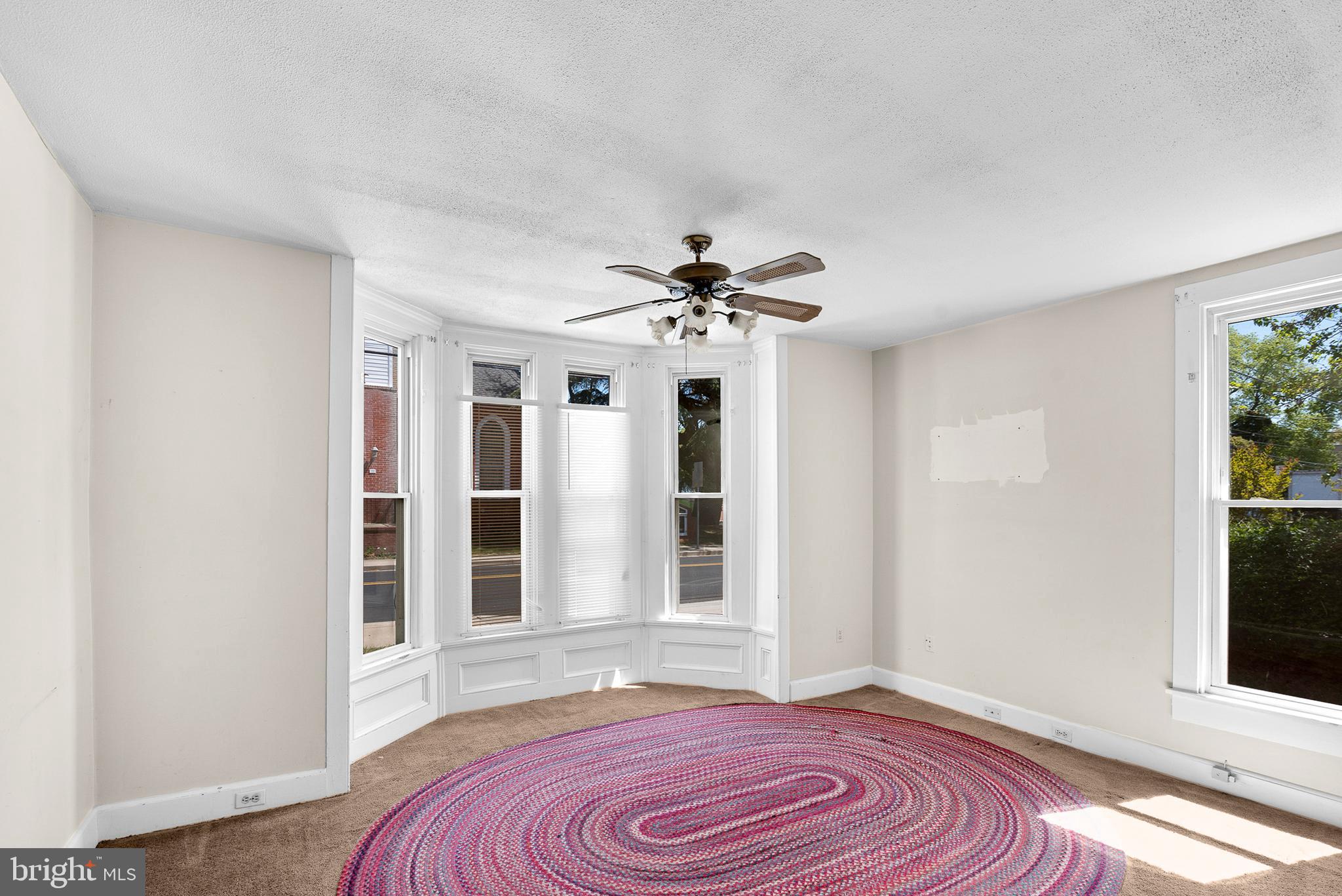 156 Main Street Preston, MD 21655 - Photo 3 of 18 a view of a livingroom with wooden floor and a ceiling fan