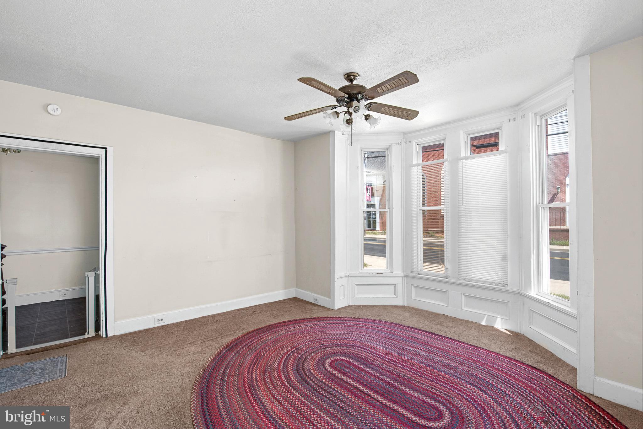 156 Main Street Preston, MD 21655 - Photo 4 of 18 a view of a livingroom with a ceiling fan and wooden floor