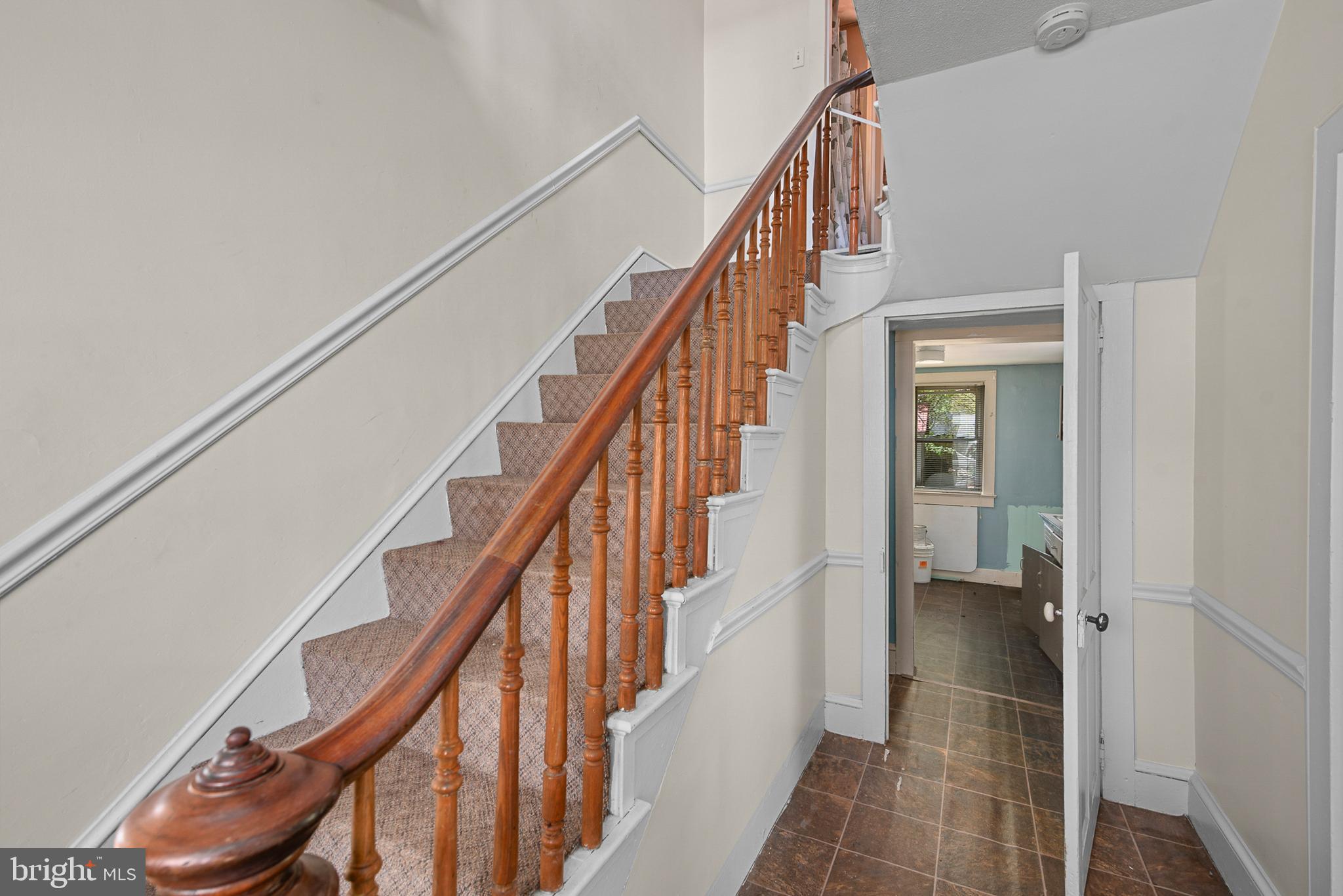 156 Main Street Preston, MD 21655 - Photo 5 of 18 a view of staircase with wooden floor and white walls