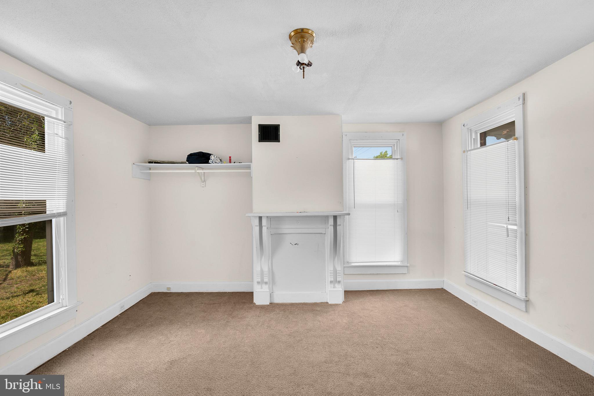 156 Main Street Preston, MD 21655 - Photo 6 of 18 an empty room with closet and windows