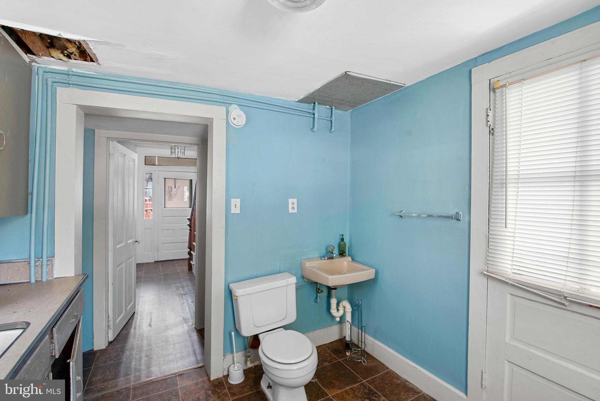 156 Main Street Preston, MD 21655 - Photo 8 of 18 a bathroom with a toilet and a sink