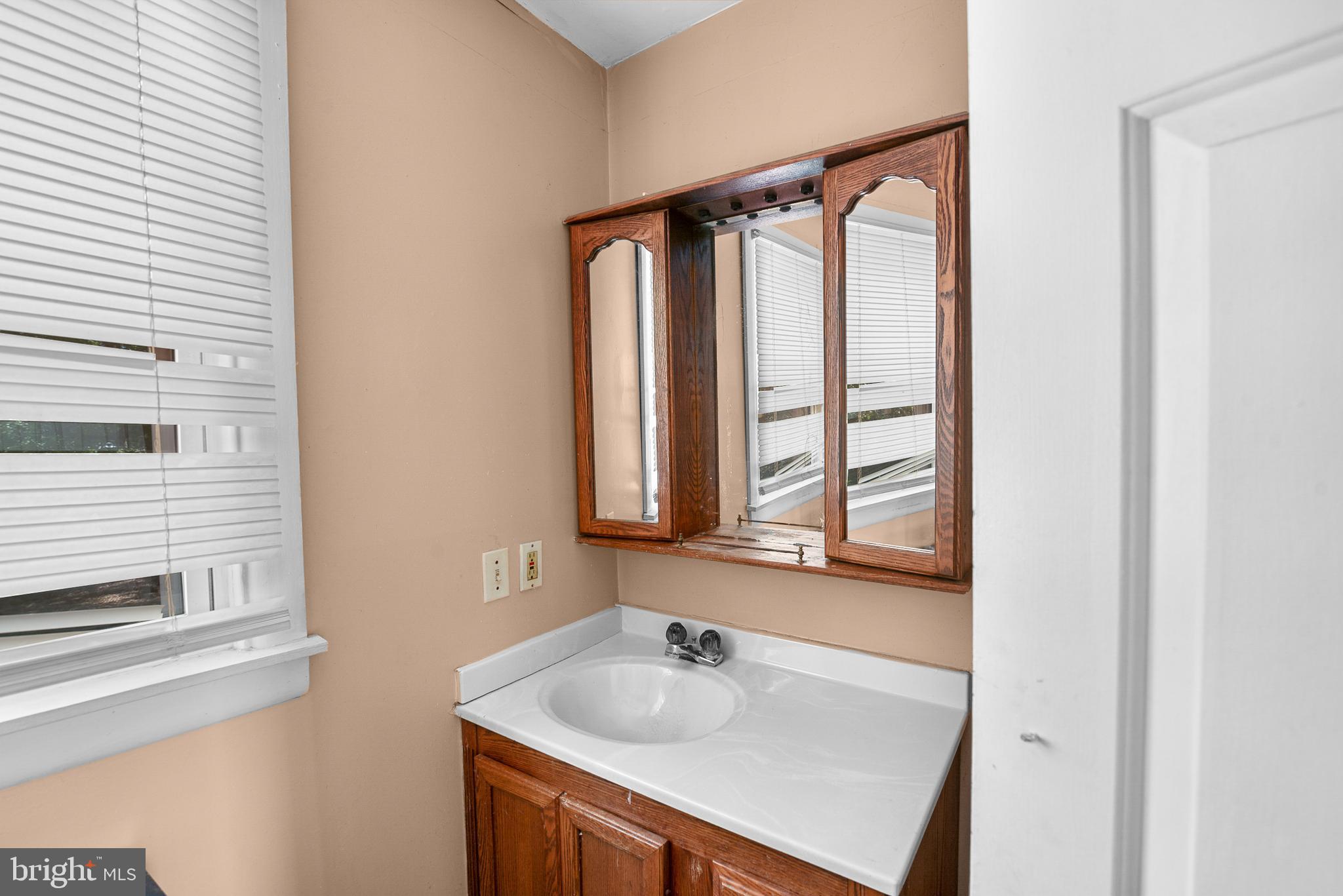 156 Main Street Preston, MD 21655 - Photo 9 of 18 a bathroom with a sink a window and a mirror