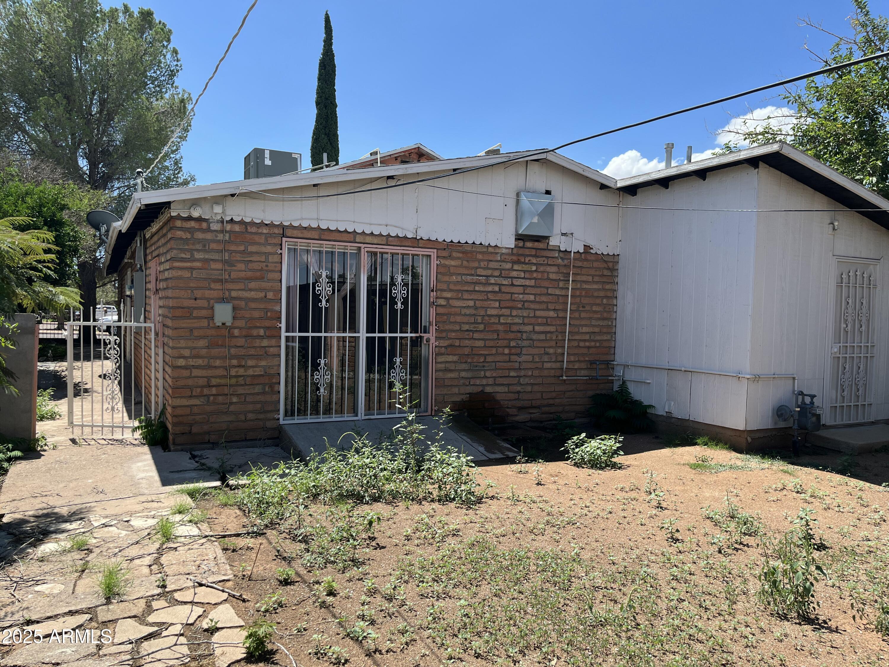 1324 6th Green Street Douglas, AZ 85607 - Photo 17 of 20 a front view of a house with a yard
