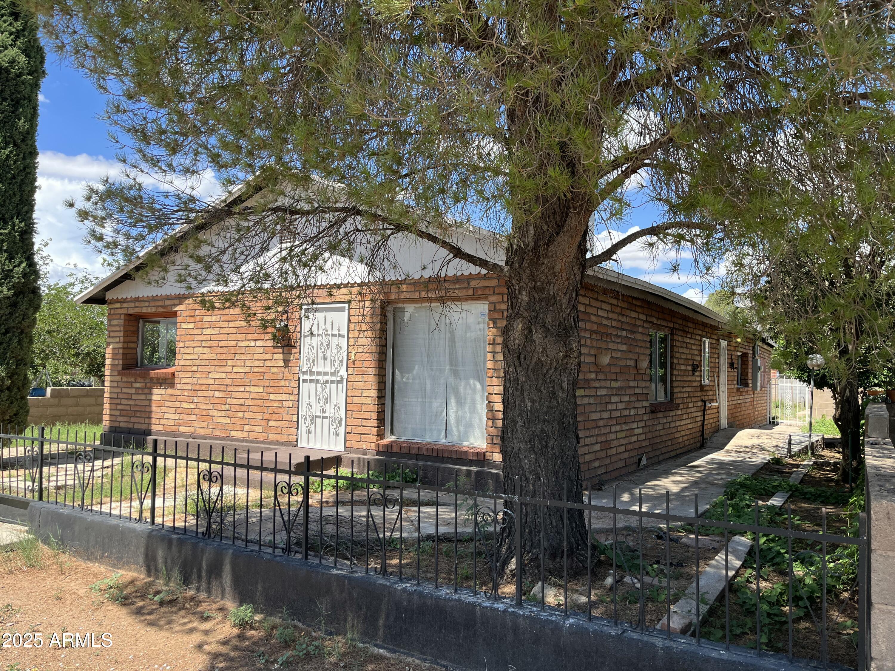 1324 6th Green Street Douglas, AZ 85607 - Photo 2 of 20 a front view of a house with a tree
