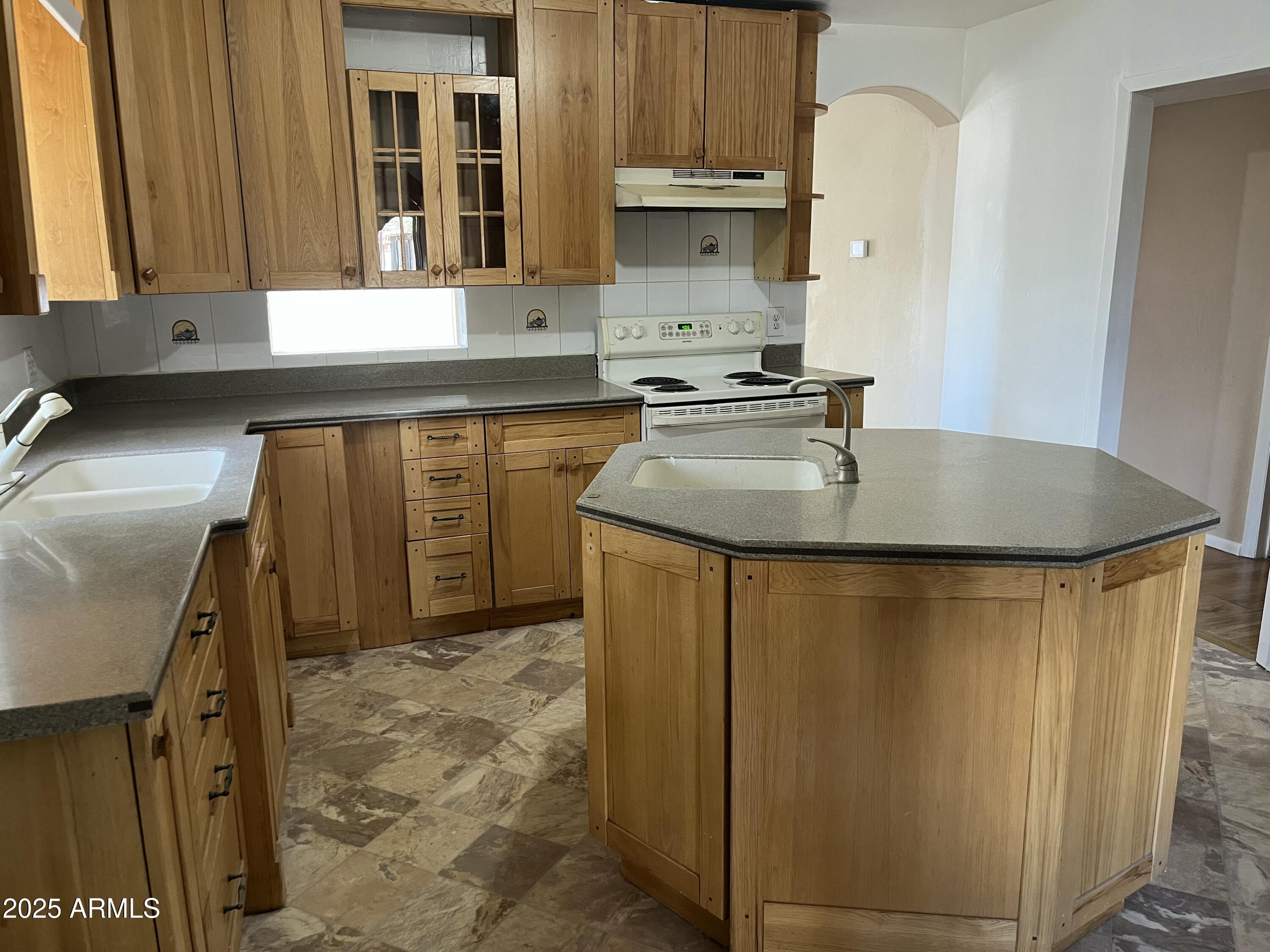 1324 6th Green Street Douglas, AZ 85607 - Photo 4 of 20 a kitchen with sink a refrigerator and a stove