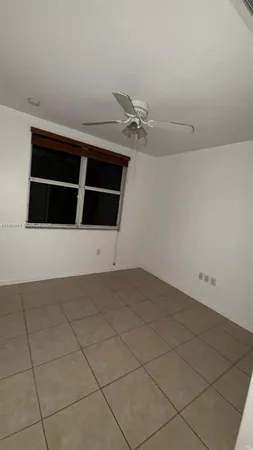 a kitchen with a refrigerator and a stove top oven