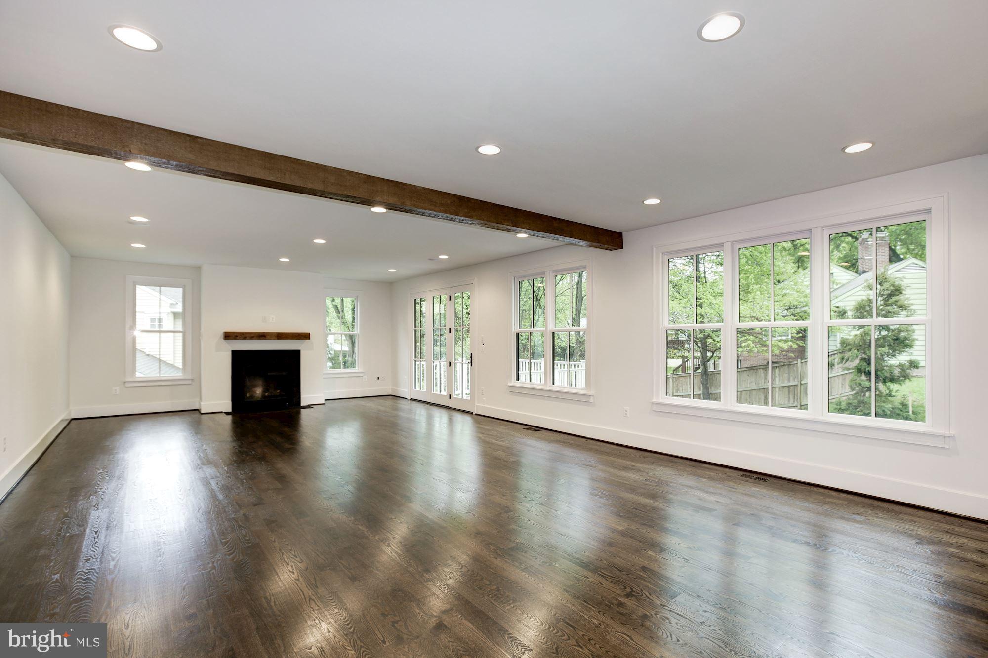 3030 North Stuart Street Arlington, VA 22207 - Photo 12 of 29 an empty room with wooden floor and fireplace