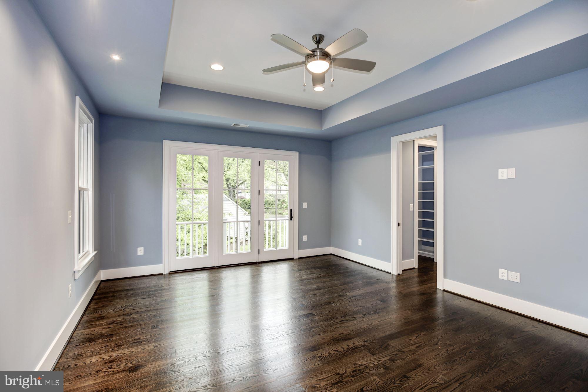 3030 North Stuart Street Arlington, VA 22207 - Photo 15 of 29 a view of an empty room with a window and wooden floor