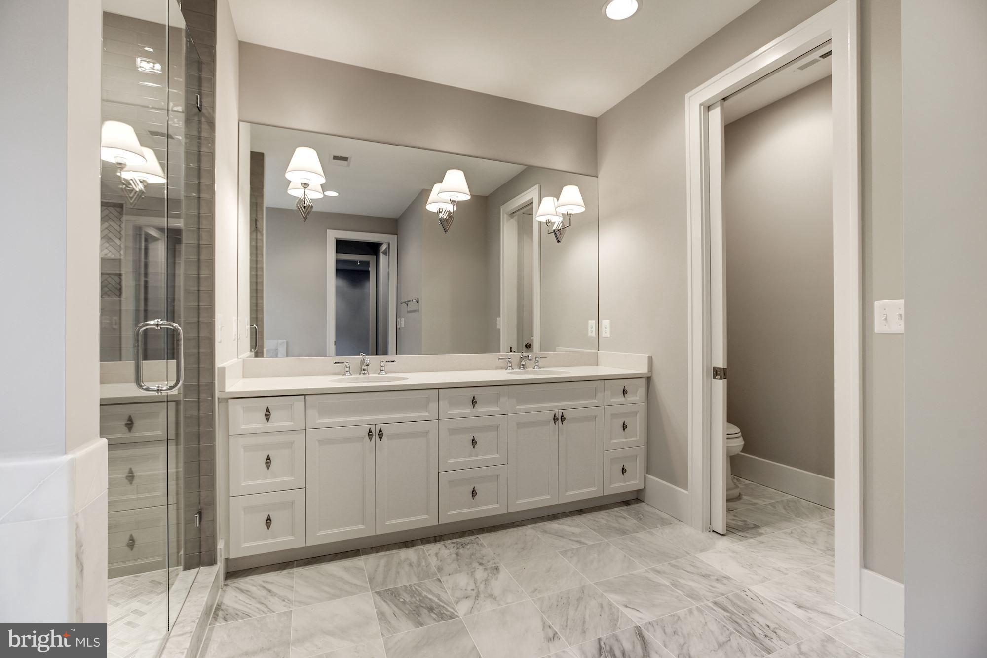 3030 North Stuart Street Arlington, VA 22207 - Photo 17 of 29 a spacious bathroom with a granite countertop sink and a mirror